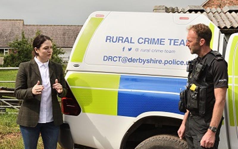 The Commissioner in front of the Rural Crime Team vehicle with an officer