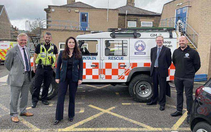 The Commissioner with officers and partners in front of a mountain rescue vehicle