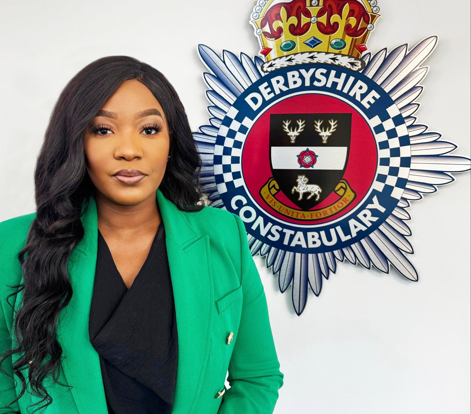 Commissioner standing next to Force Logo