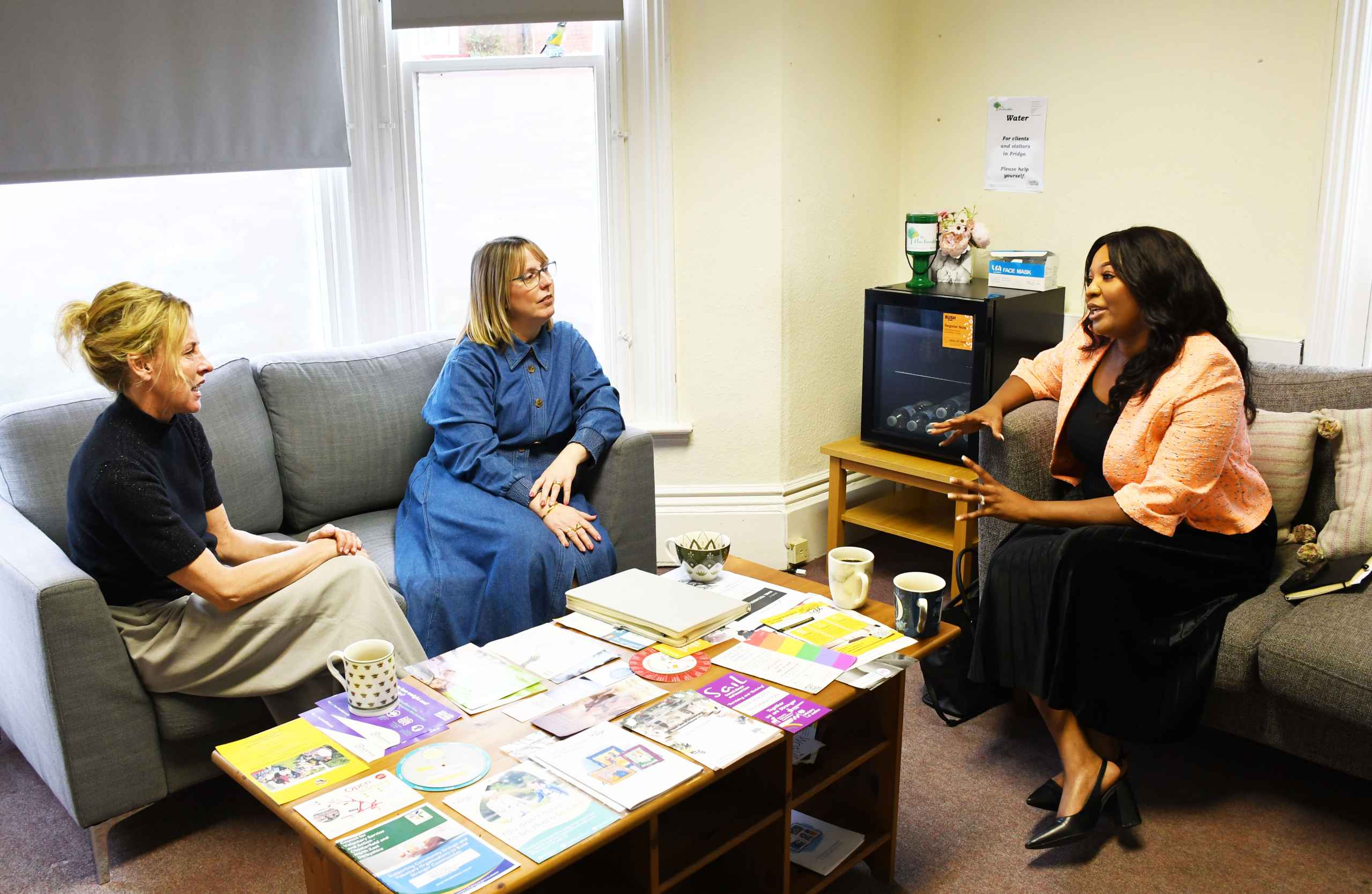 3021-DSC_3463 a Commissioner sitting in room with two other women