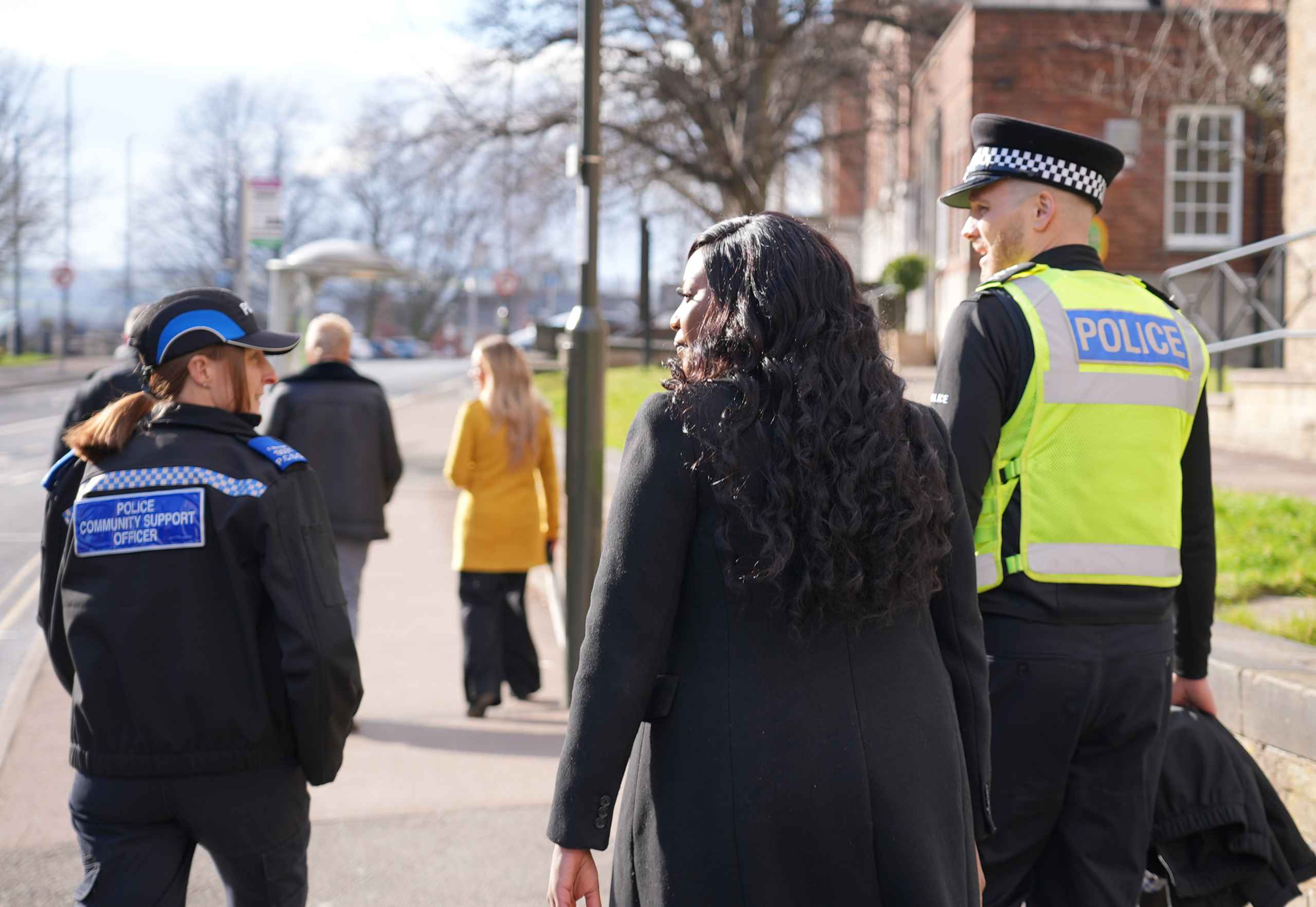 PCC and two officers walking away from camera along pavement
