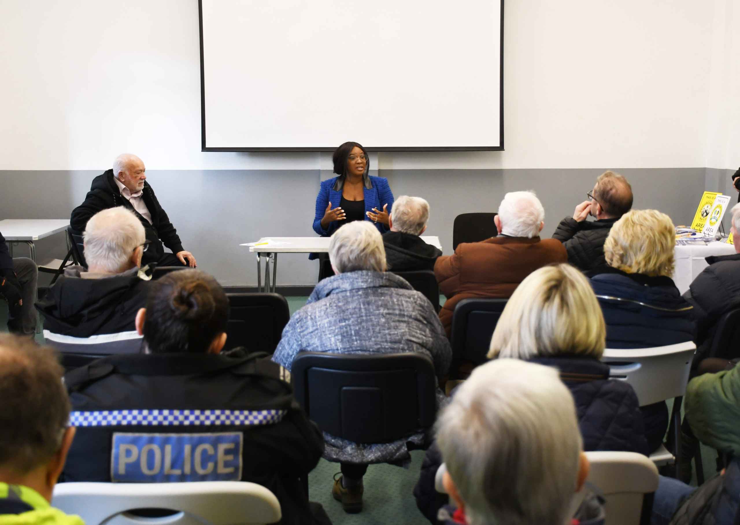 Commissioner at front of room full of people