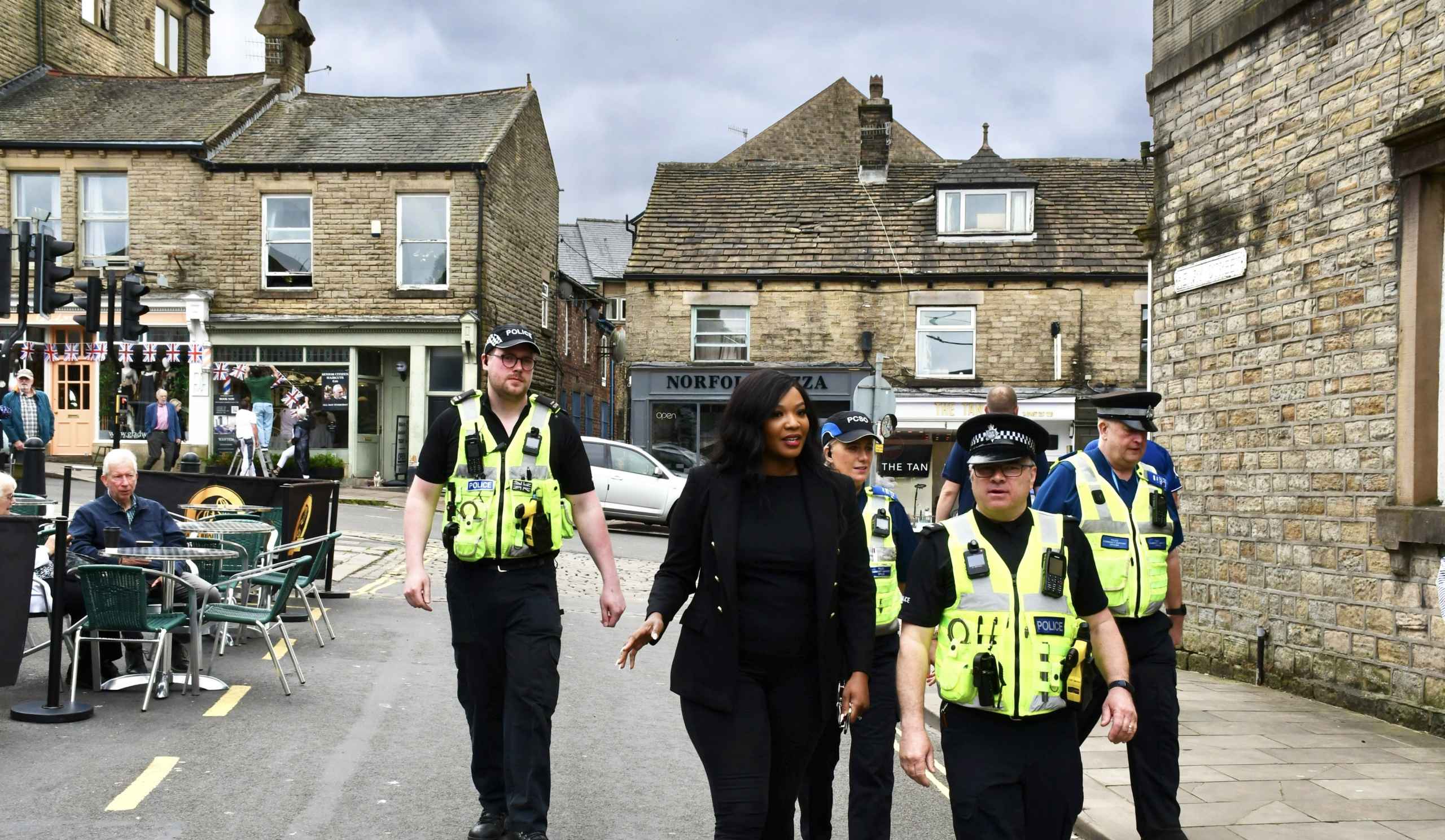 Commissioner with a group of 4 officers walking along a local street